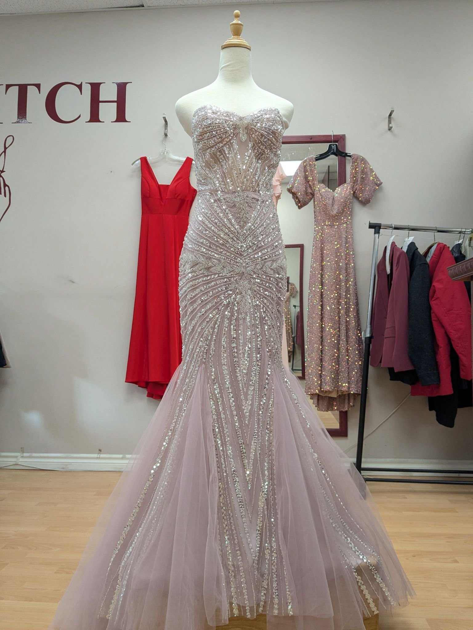 Lavender beaded mermaid evening gown on mannequin in Top Stitch tailoring shop