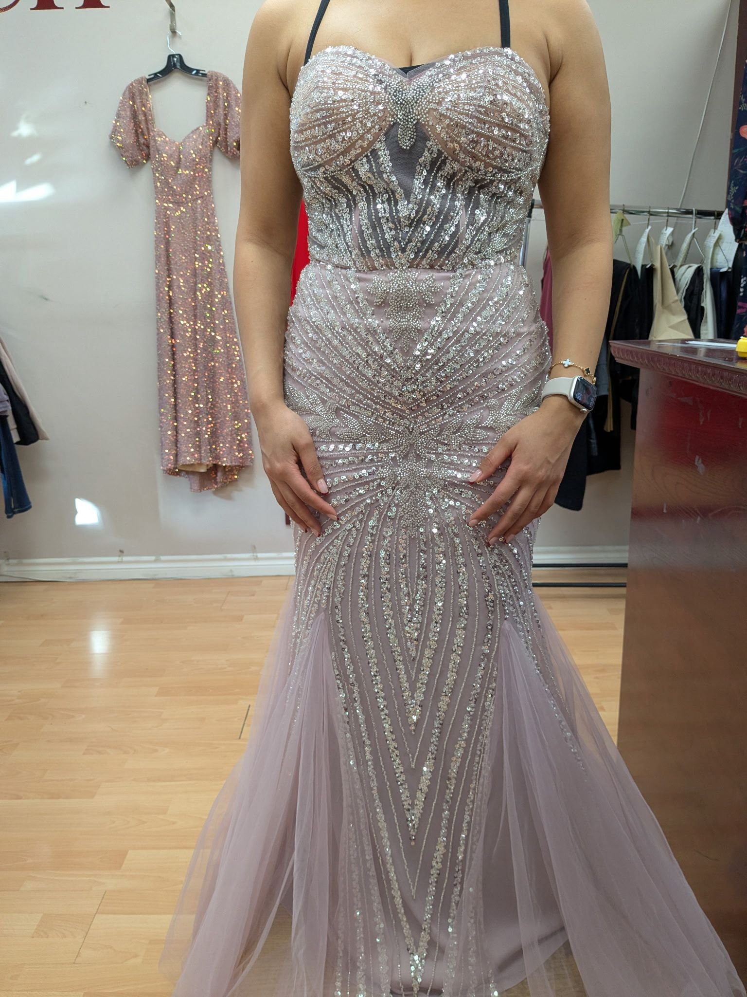 Woman wearing beaded lavender sweetheart neckline mermaid gown with all-over sequin detailing