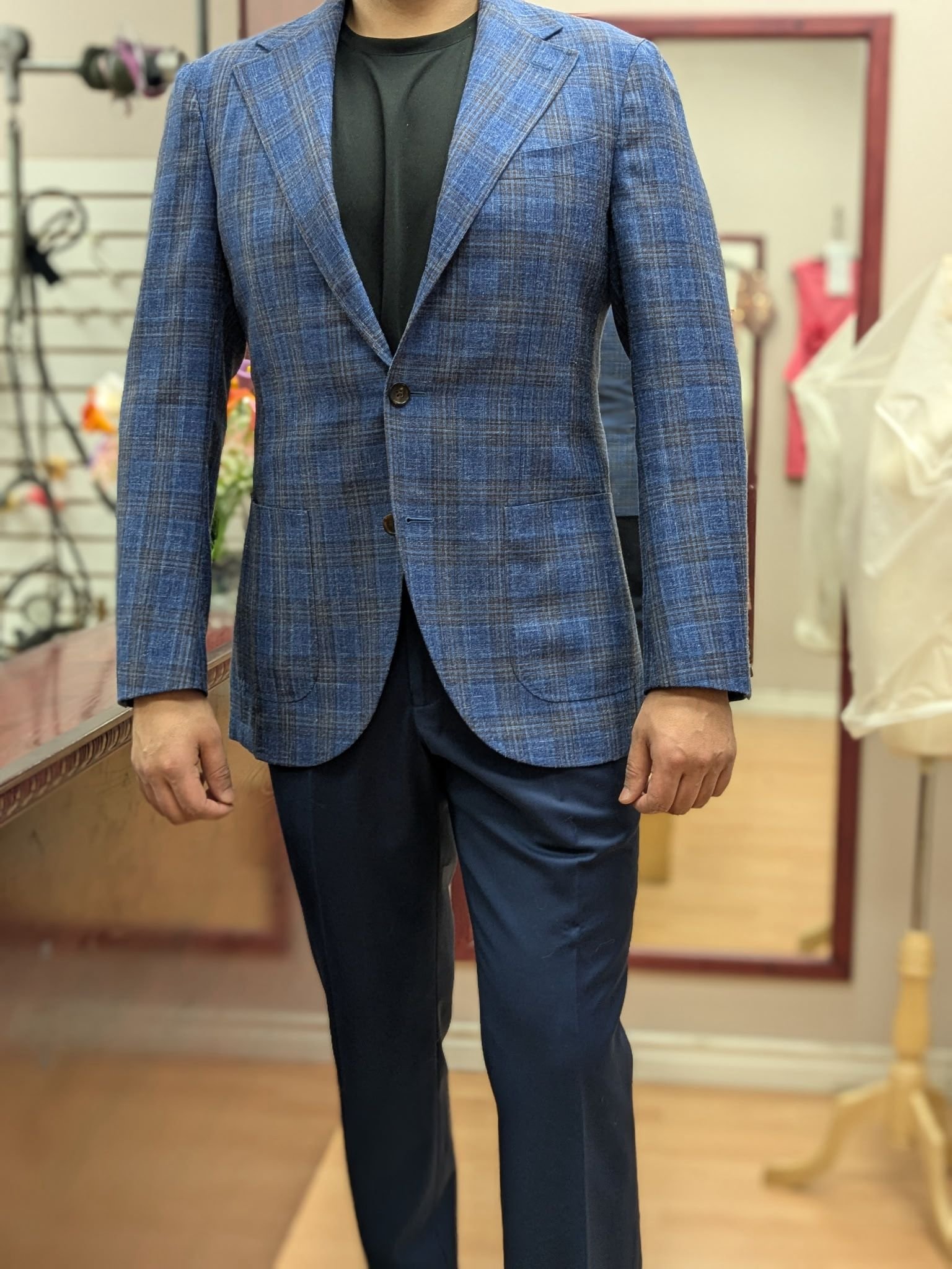 Man wearing tailored blue plaid blazer with black shirt at Top Stitch Mississauga fitting